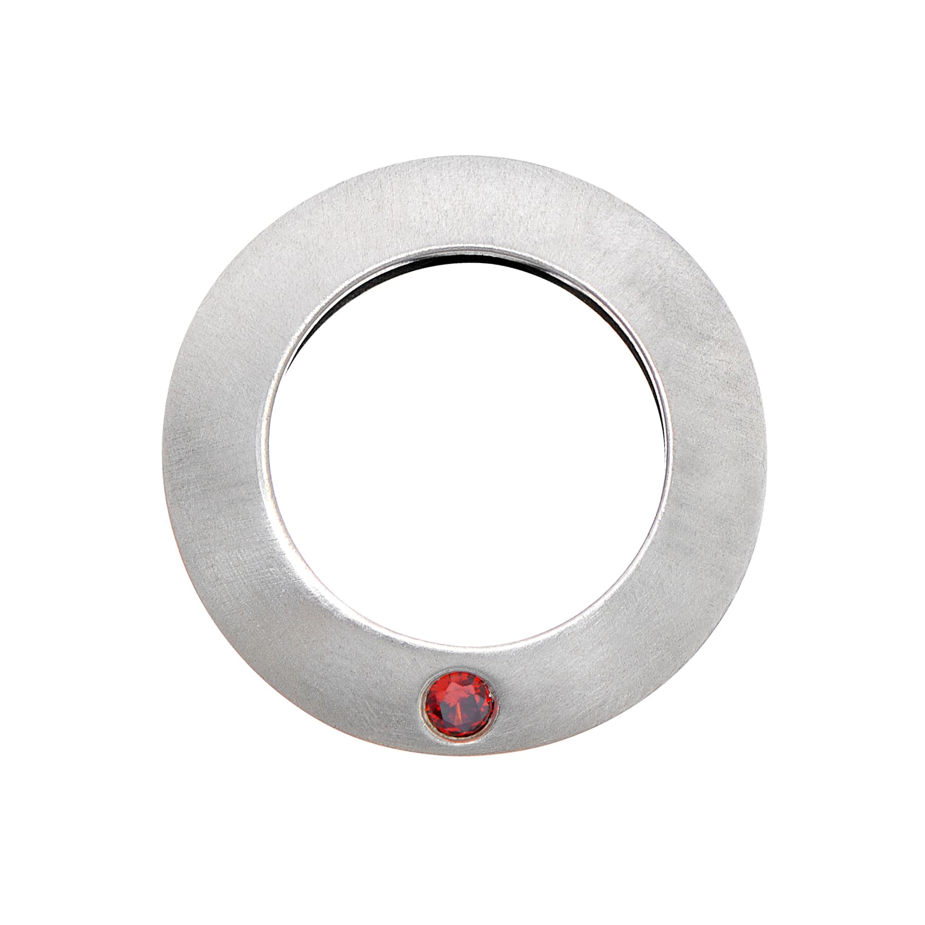 A circular brushed silver ring featuring a single round red garnet gemstone set at the bottom against a white background