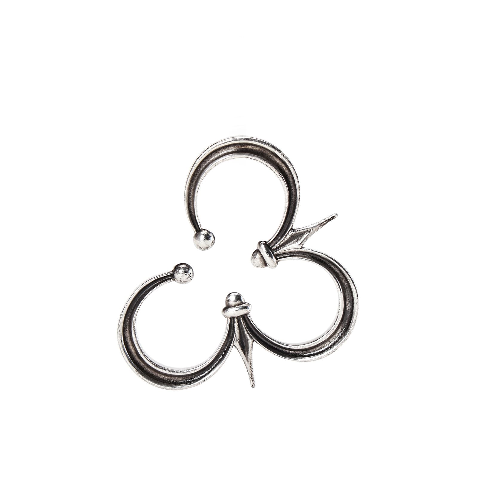 A silver cuff earring with three interconnected crescent shapes and pointed accents on a white background