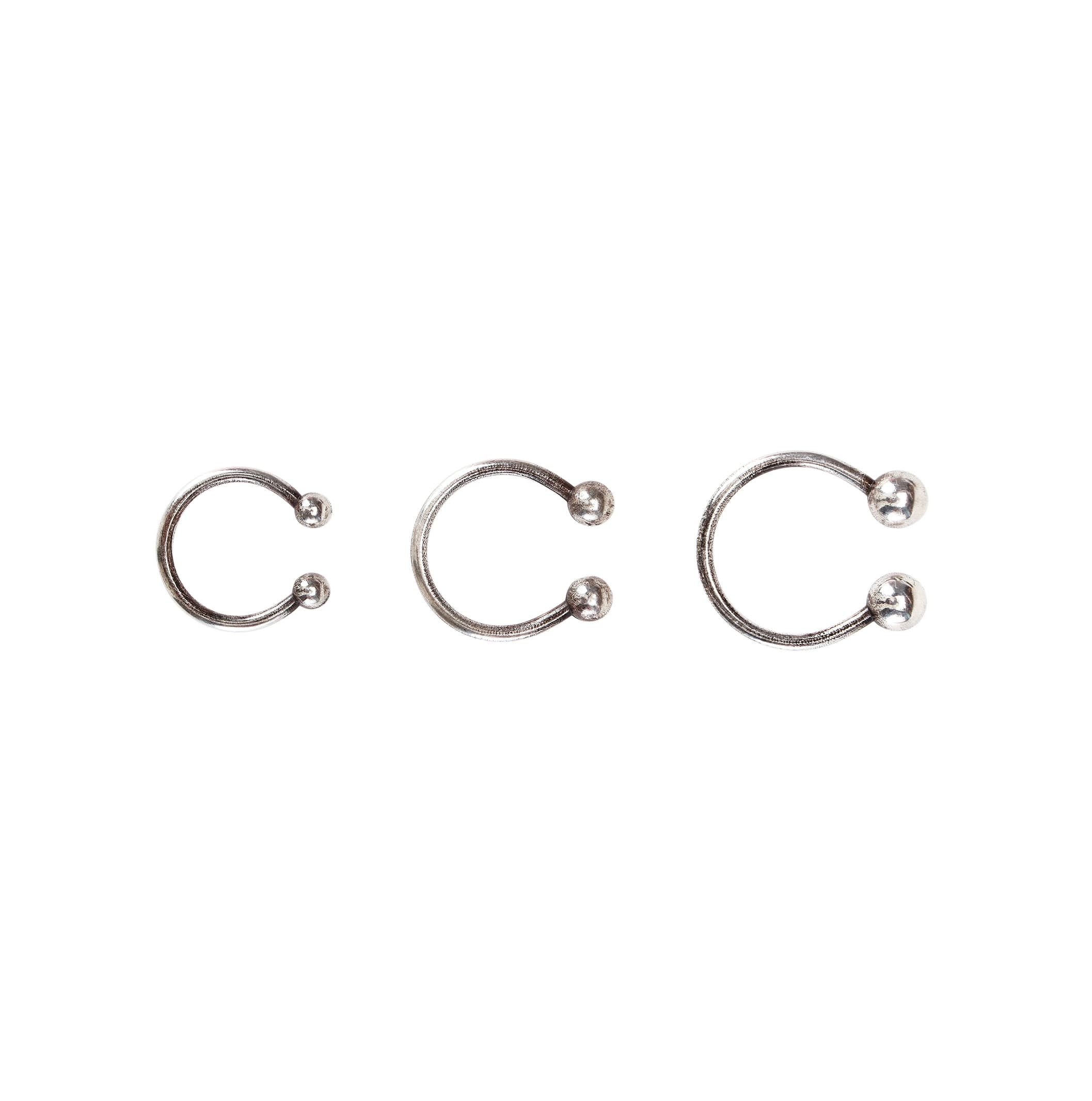 Three silver horseshoe-shaped rings in graduating sizes arranged in a row against a white background