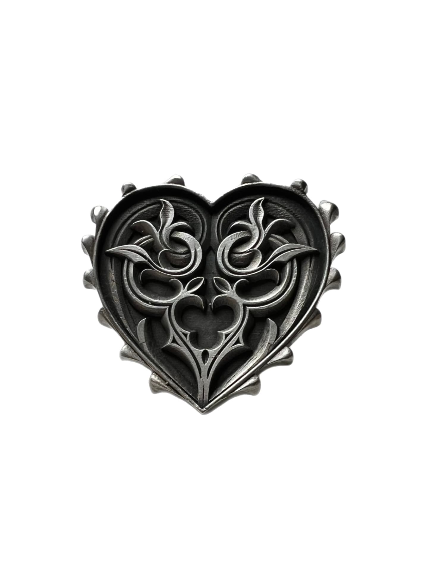 A heart-shaped silver earring featuring intricate gothic filigree carvings and a studded border on a white background